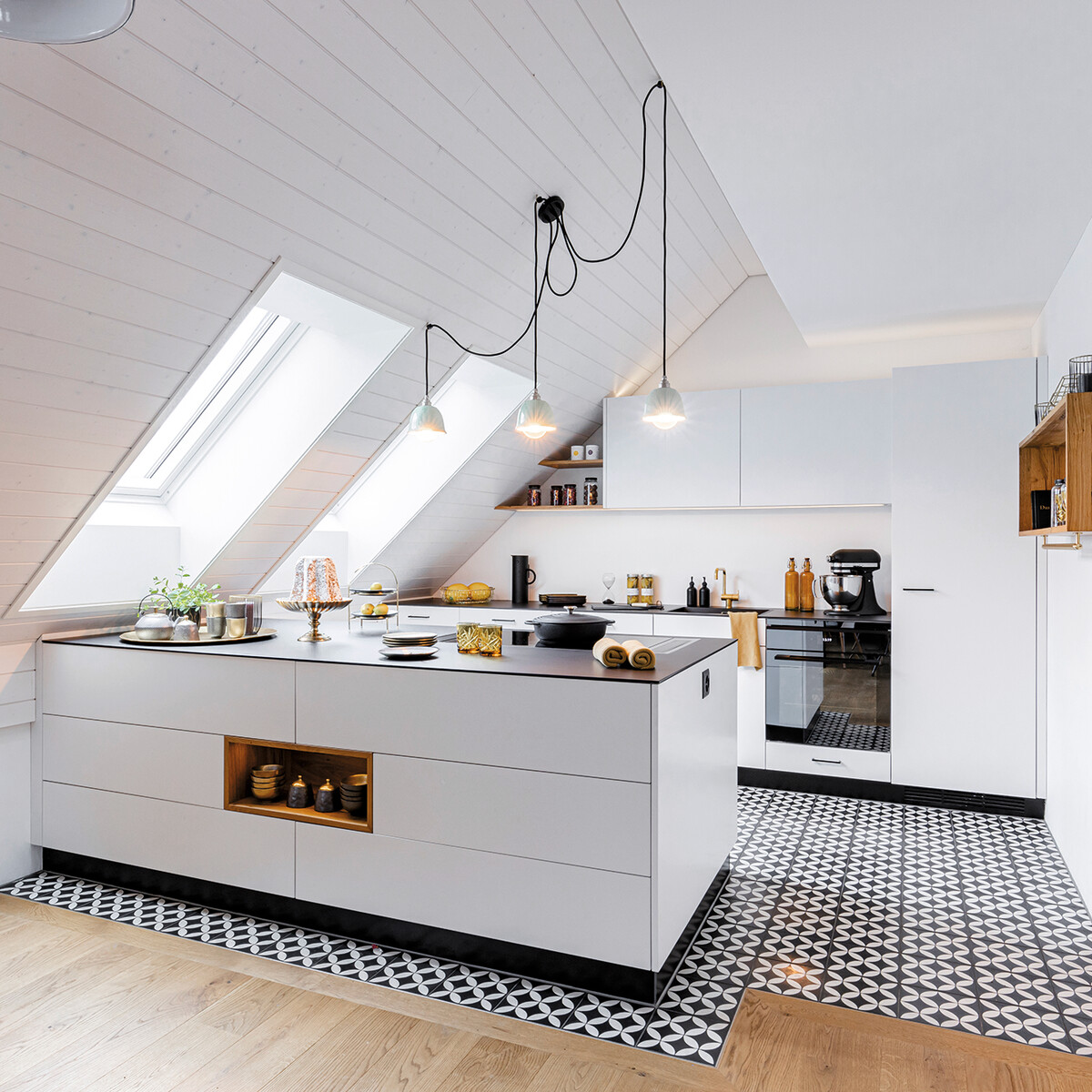 Weisse Küche mit prägnant gemusterten Bodenplatten.